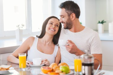 Young couple smiling in kitchen