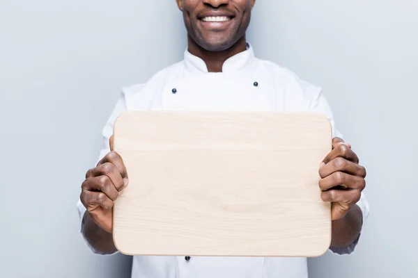African chef  holding wooden cutting board — Stock Photo, Image