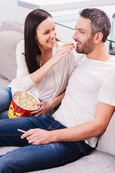 Jovem casal amoroso comer pipocas — Fotografia de Stock