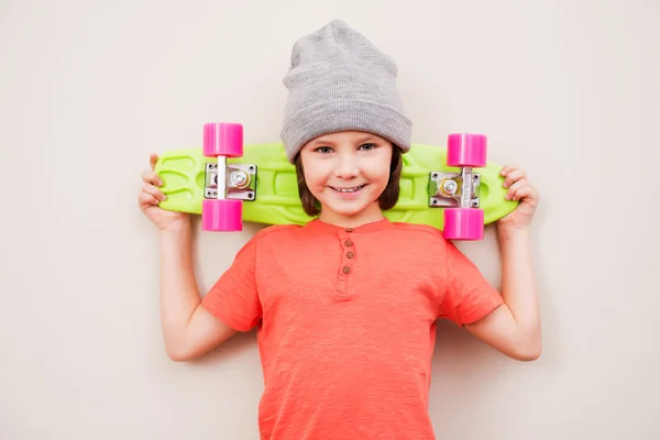 Malý chlapec hospodářství barevné skateboard — Stock fotografie