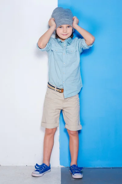 Handsome little boy adjusting hat — Stock Photo, Image