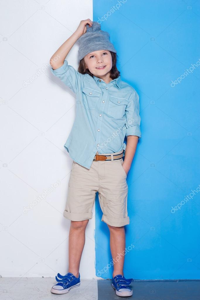 Handsome little boy adjusting hat