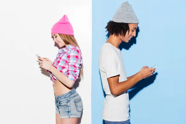 Mladý pár hospodářství mobilních telefonů — Stock fotografie