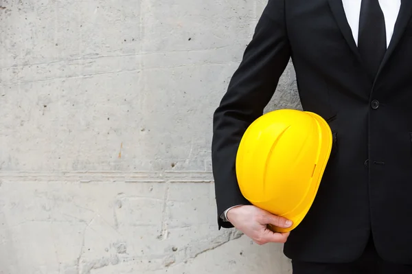 Businessman holding hardhat — Stock Photo, Image