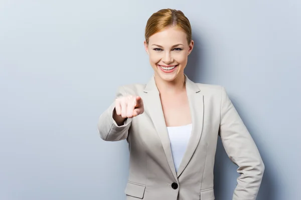 Beautiful young businesswoman pointing — Stock Photo, Image