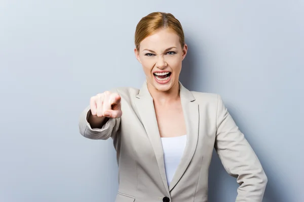 Young angry businesswoman pointing — Stock Photo, Image