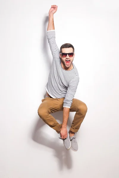 Excited young man jumping — Stock Photo, Image
