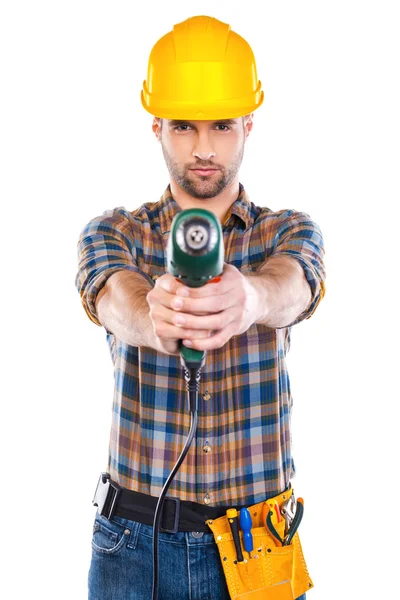 Young male carpenter stretching out drill — Stock Photo, Image