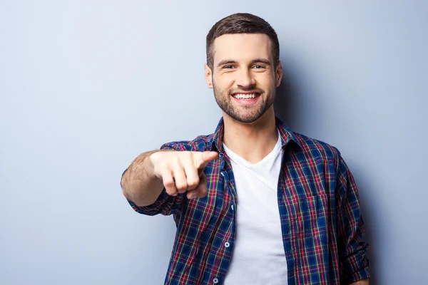 Handsome man in casual shirt pointing — Stock Photo, Image