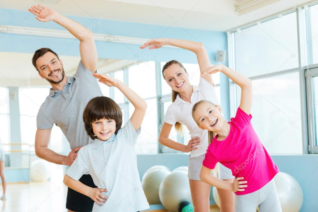 Happy sporty family doing stretching