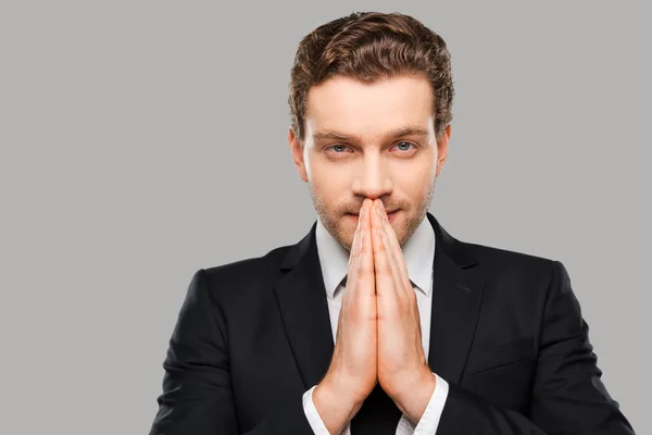 Man in formalwear holding hands clasped — Stock Photo, Image