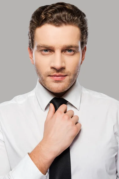 Man in shirt and tie adjusting  necktie — Stock Photo, Image