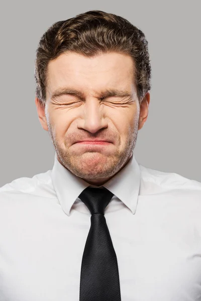 Frustrated young man in shirt and tie — Stock Photo, Image