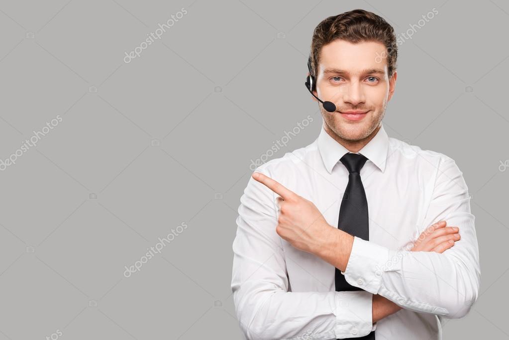 Man in headset pointing away