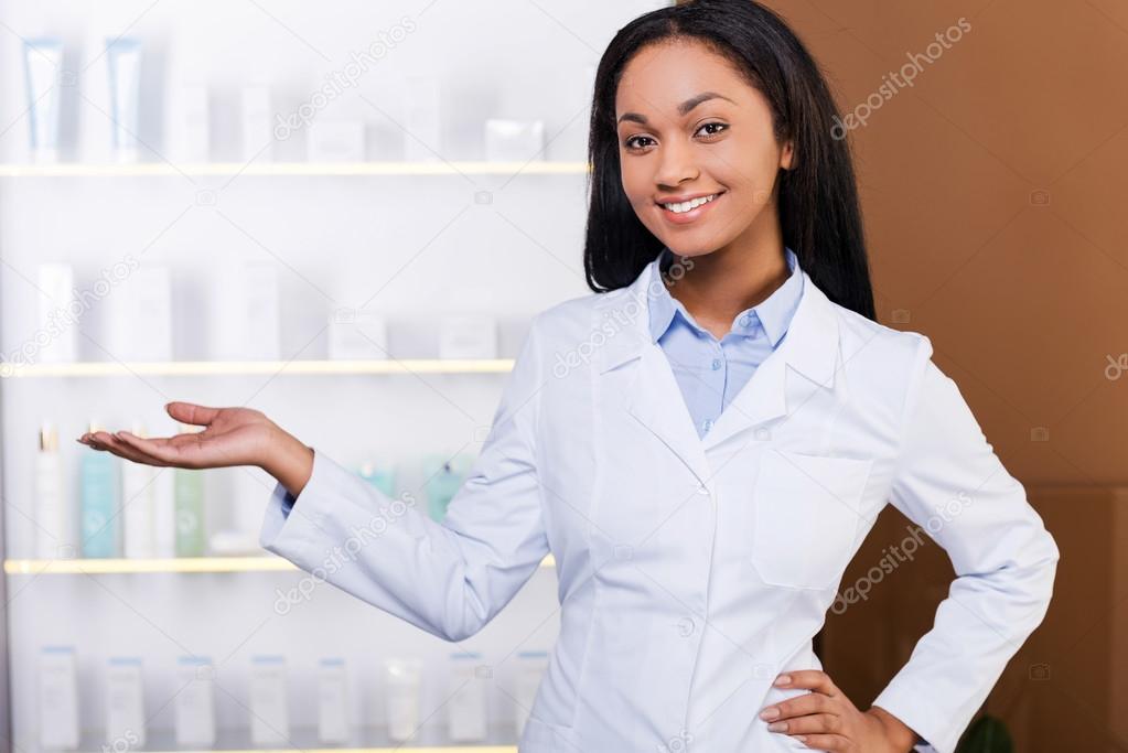 Woman in lab coat in drugstore