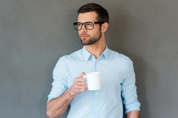 Man in shirt in eyewear holding cup — Stock Photo, Image
