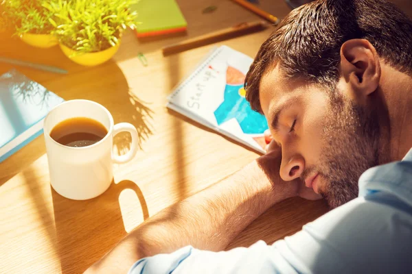 Tired man sleeping at working place — Stock Photo, Image