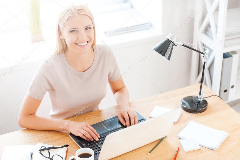 Woman sitting at working place in office