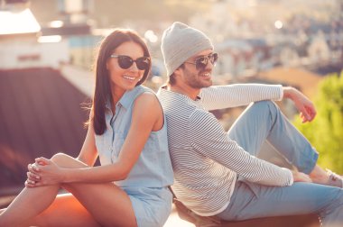 Çift oturma çatıda sırt sırta