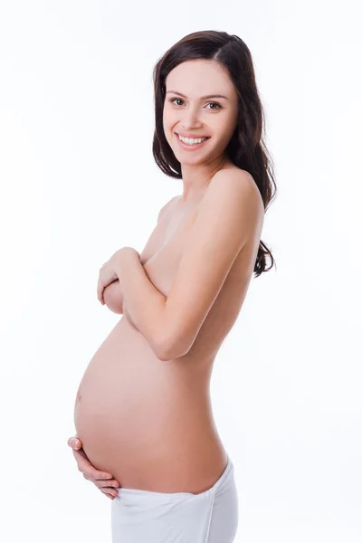 Mulher grávida de mãos dadas no abdômen — Fotografia de Stock