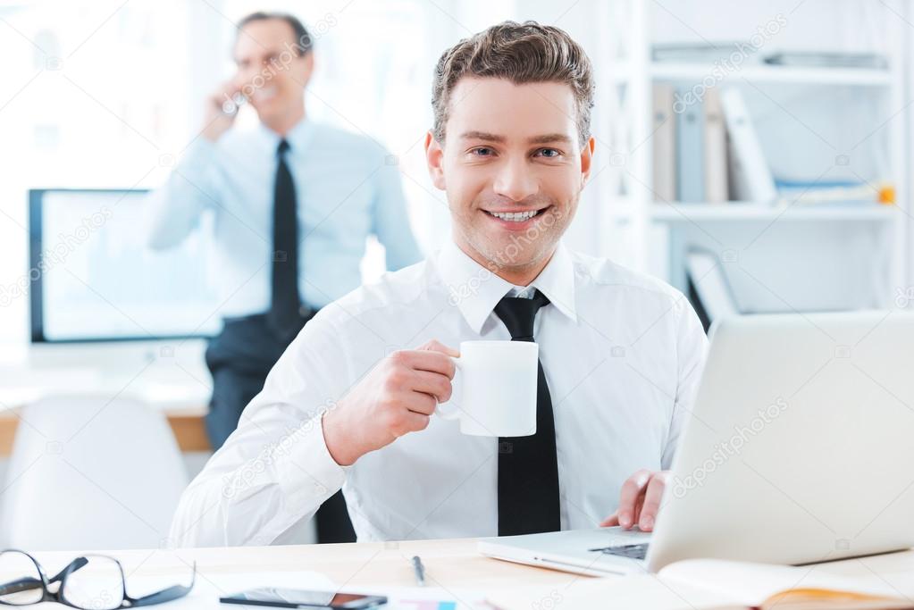 Businessman holding cup of coffee