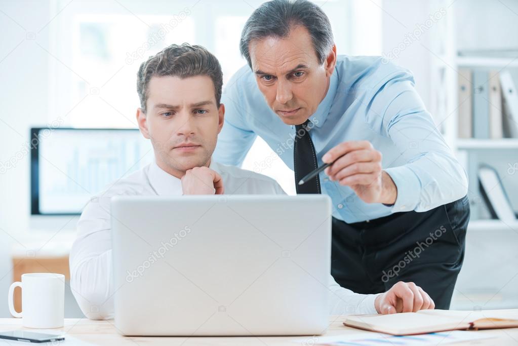 Business people  looking at laptop