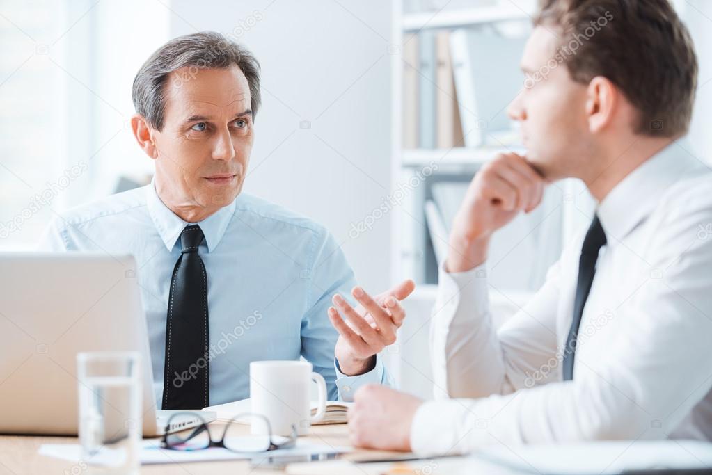 Business people sitting at working place