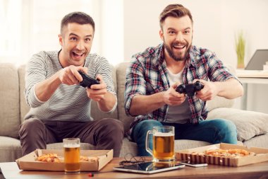 Happy men playing video games clipart