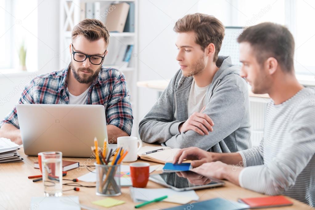 Confident men working at working place