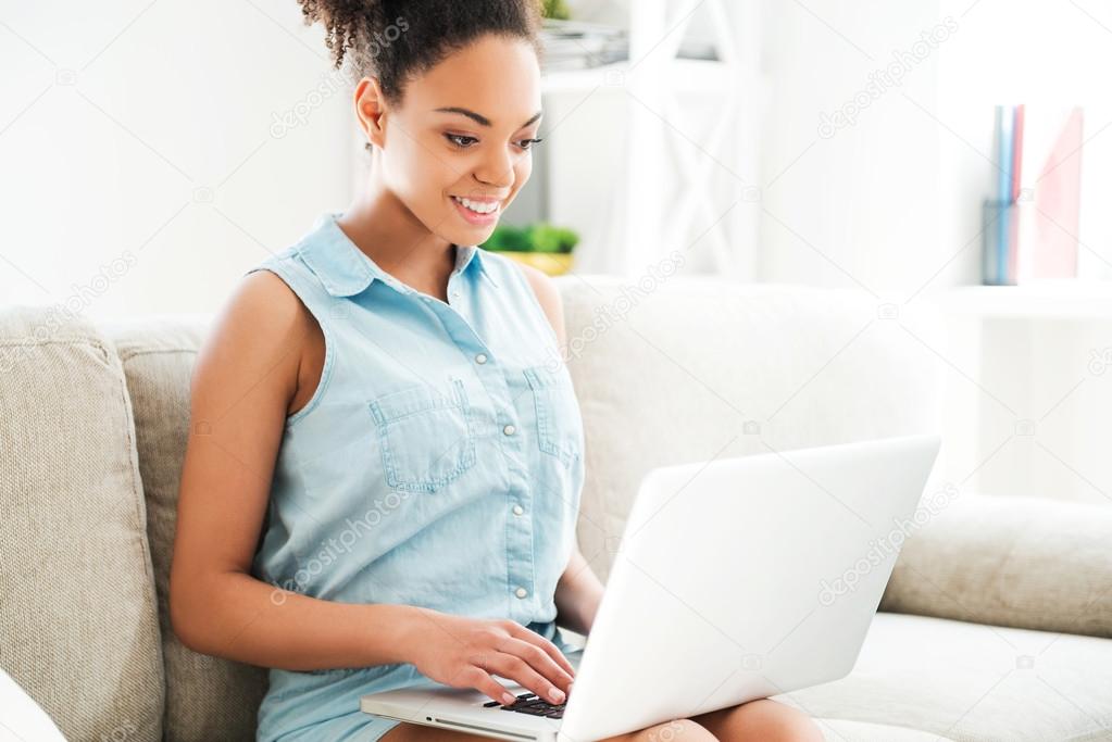 African woman working on laptop