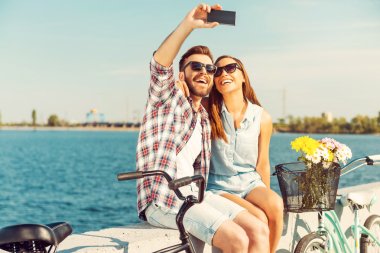 couple making selfie near bicycles clipart
