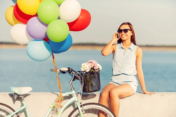 Woman holding colorful balloons — Stock Photo, Image