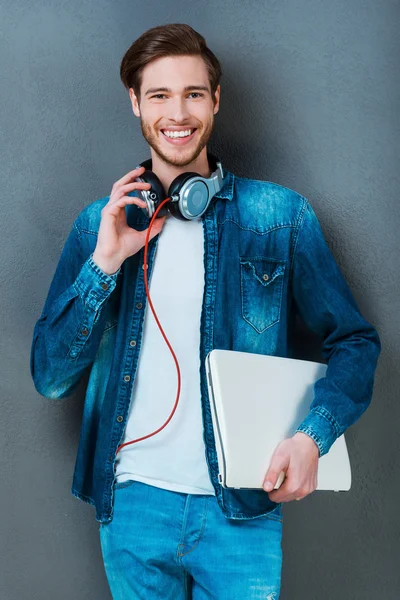 Happy young man holding laptop — Stock Photo, Image