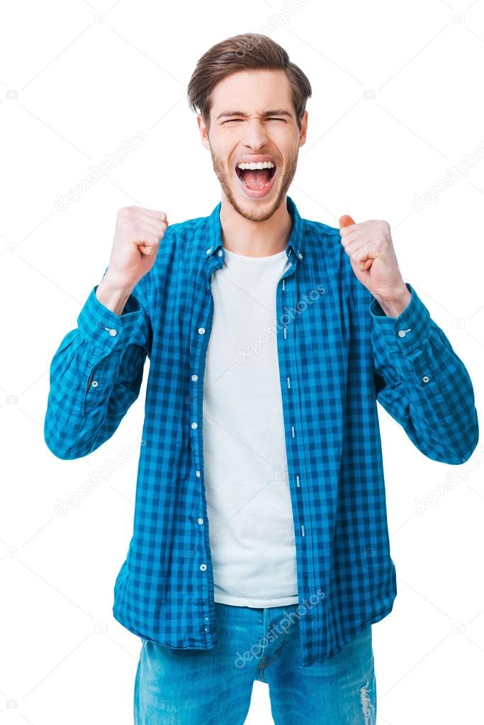 Cheerful young man keeping arms raised