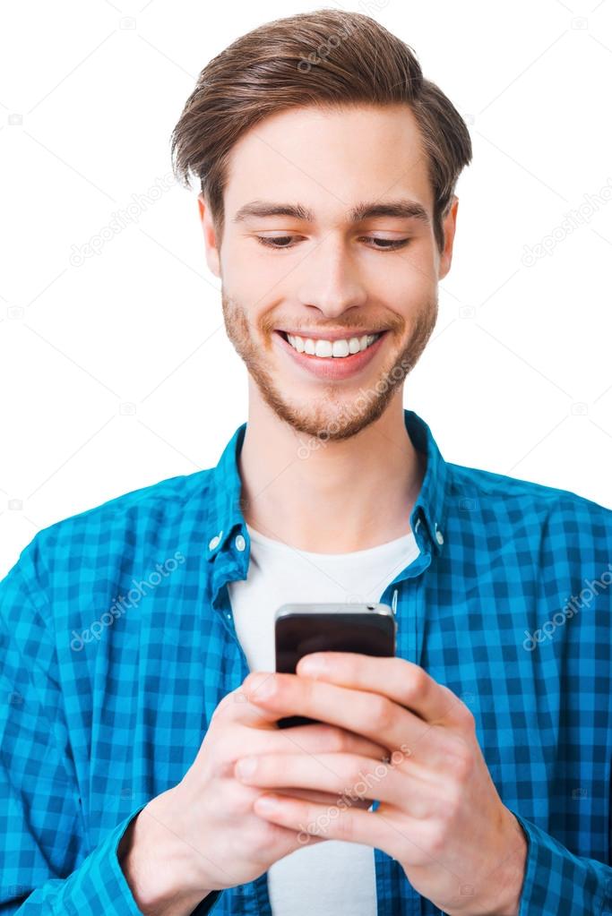 young man in shirt holding mobile phone