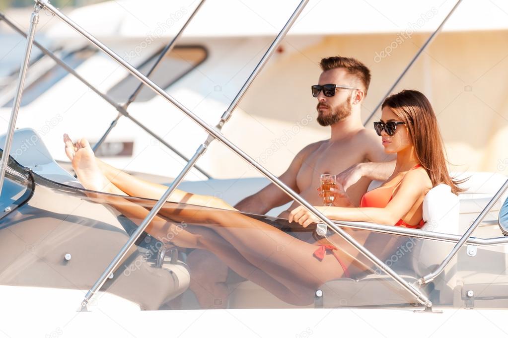 couple sitting on board of yacht