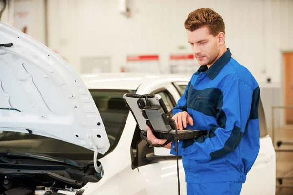 Man aan het werk op speciale laptop in werkplaats — Stockfoto