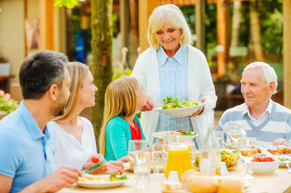 family enjoying meal together  outdoors