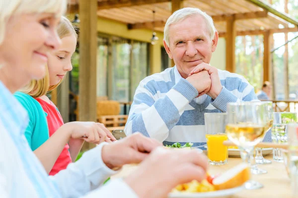 Hombre mayor buscando disfrutar de la cena con la familia —  Fotos de Stock