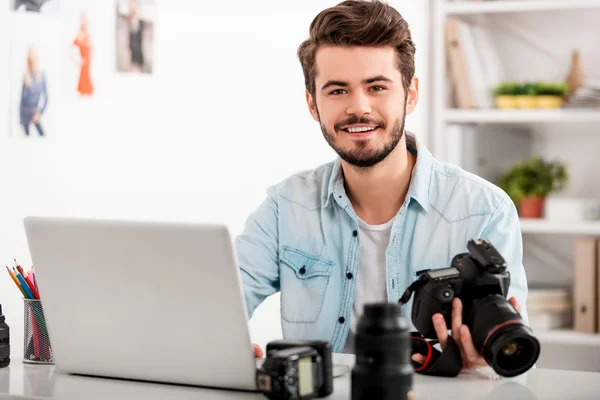 man holding camera at working place