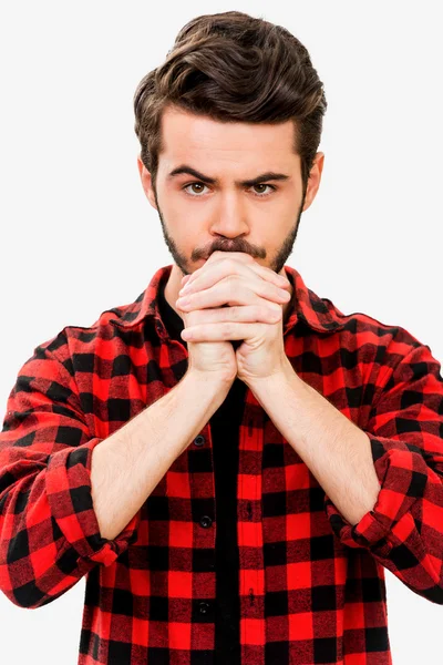 Thoughtful young man holding hands clasped — Stock Photo, Image