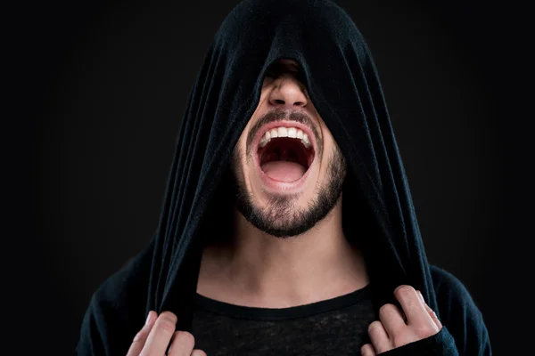 Man covering face by hood and shouting — Stock Photo, Image