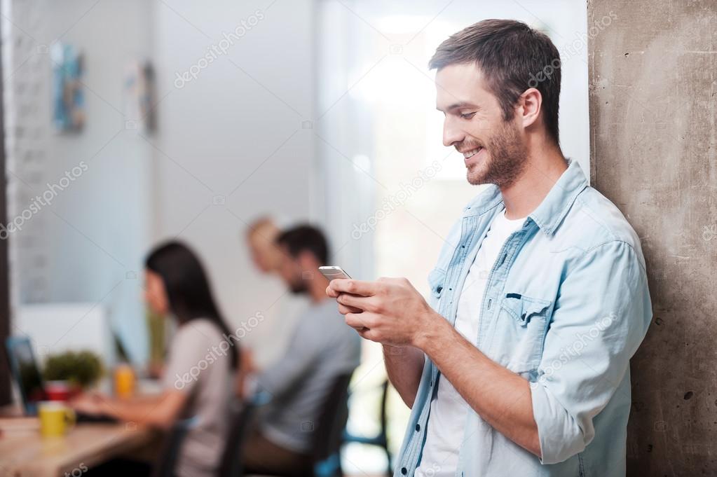 man looking at his mobile phone