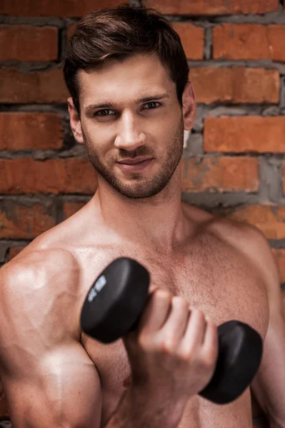 Kaslı adam dumbbells ile eğitim — Stok fotoğraf