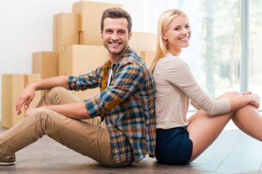 couple sitting on floor of new apartment