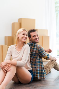 couple sitting on floor of new apartment