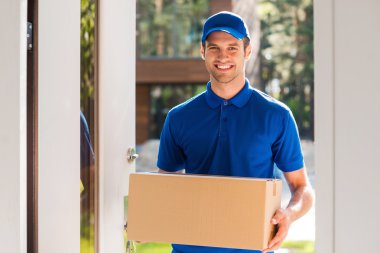 courier holding cardboard box