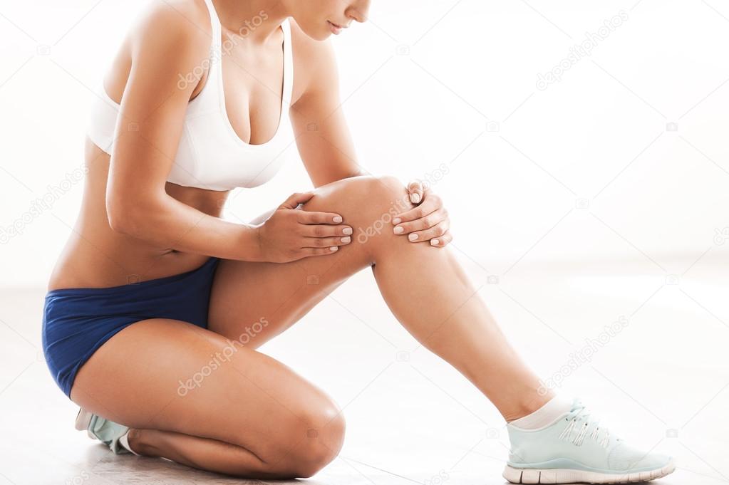 woman touching her injured knee