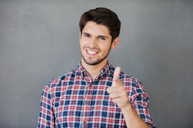 Cheerful man pointing at camera