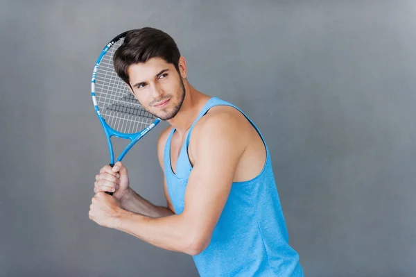 Musculoso hombre sosteniendo raqueta de tenis —  Fotos de Stock